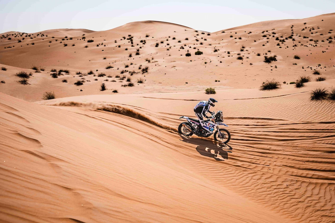 Enduro riding in the dunes. Sahara desert landscape.